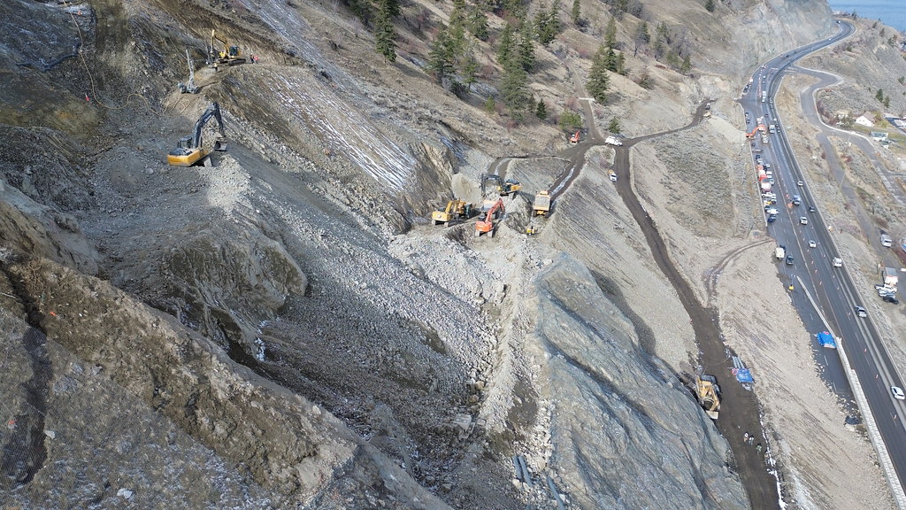 Aerial view of slope stabilization work at the North Beach slide above Highway 97 north of Summerland, with traffic moving below